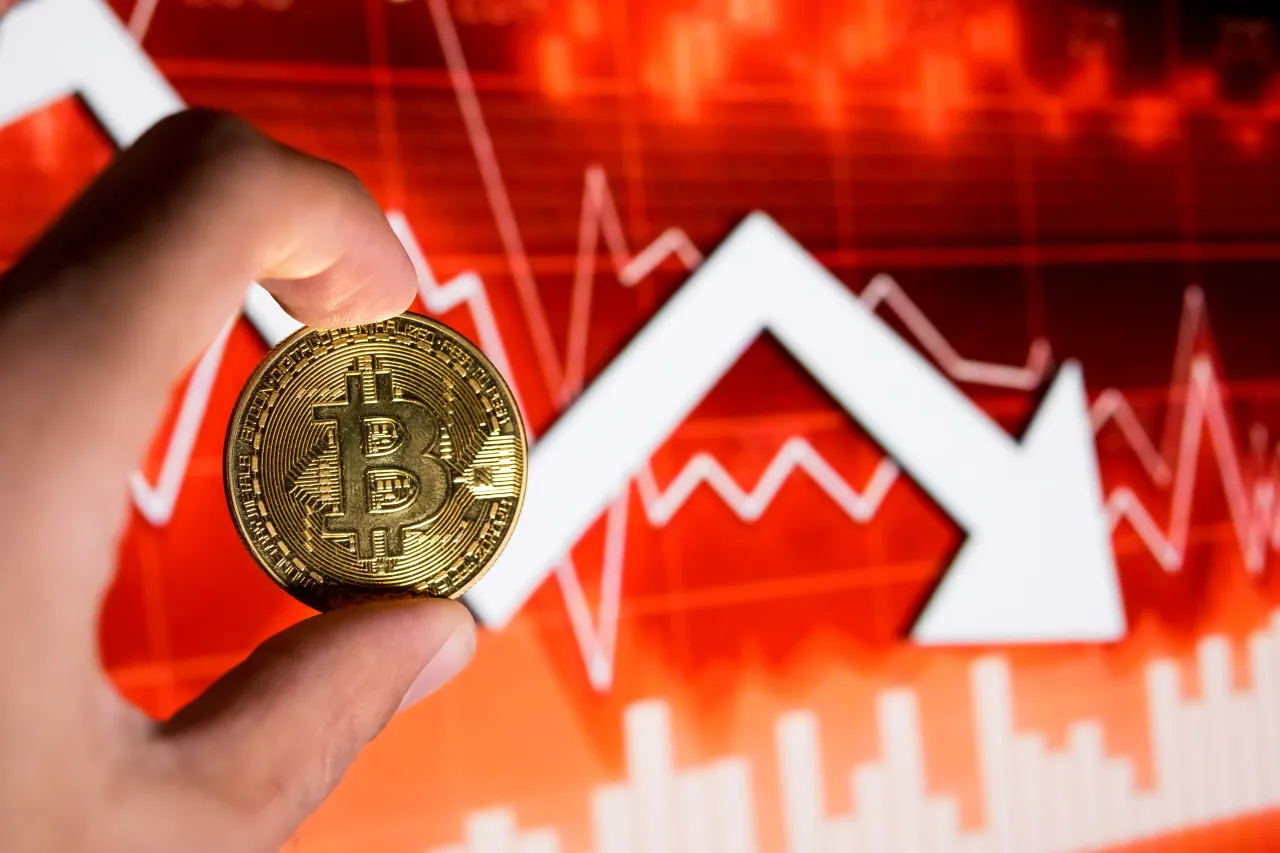 A physical representation of Bitcoin and an exchange rate arrow appear on a computer screen as the background in this photo illustration in Athens, Greece, on February 5, 2026. (Photo by Nikolas Kokovlis/NurPhoto via Getty Images)