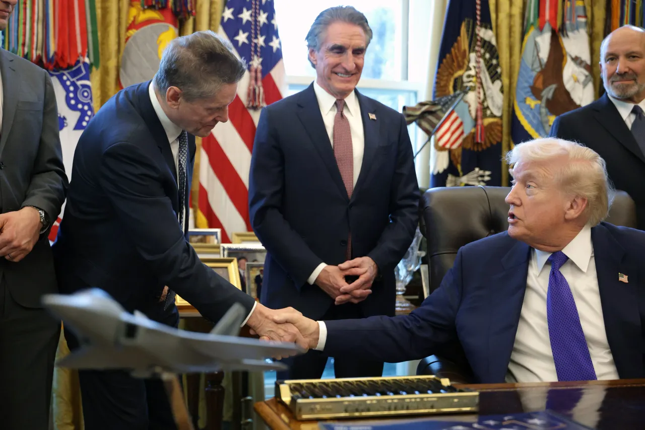 U.S. President Donald Trump shakes hands with Robert Friedland, mining industry financier.