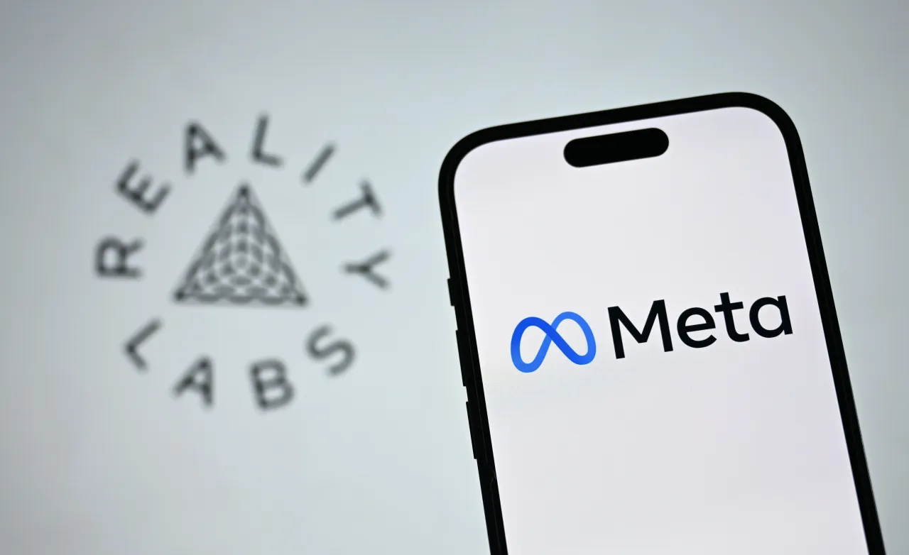 In this photo illustration, Meta logo is displayed on a mobile phone in front of a Reality Labs logo.