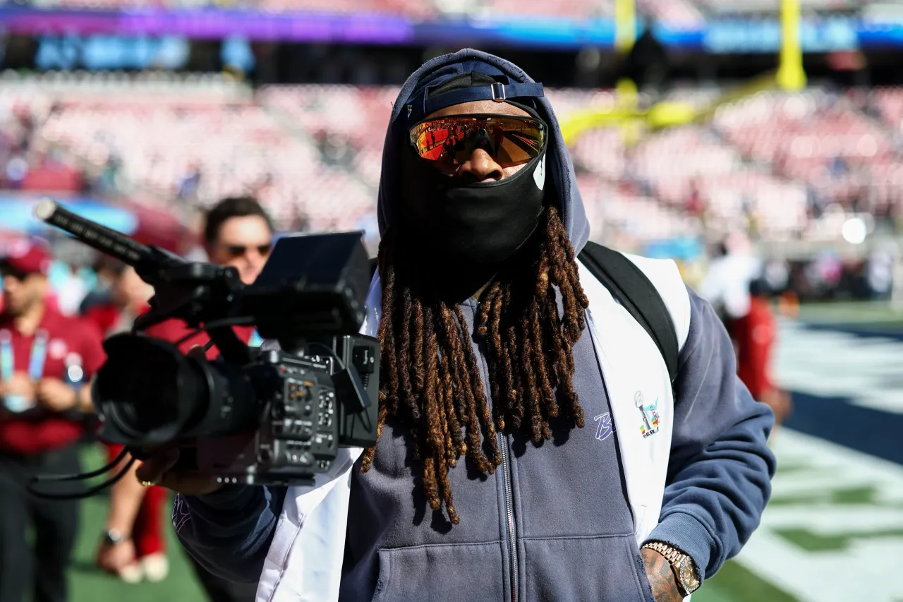 Former NFL player Marshawn Lynch stands with a camera at Levi's Stadium on February 8, 2026 in Santa Clara, California. 
