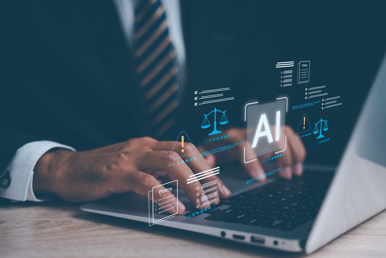 Businessman working on laptop with artificial intelligence law icons showing regulation, ethics and compliance standard. (Source: Getty Images)