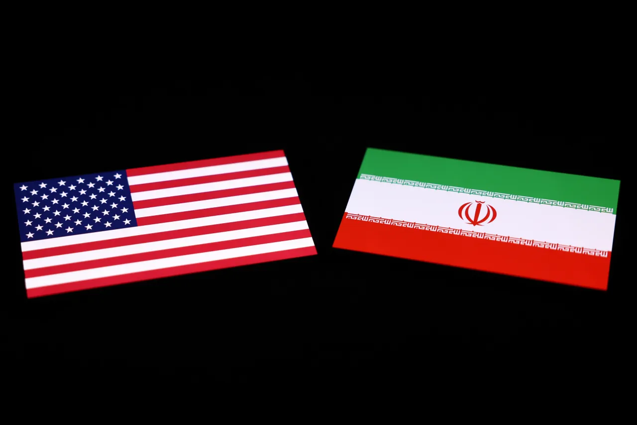 American and Iranian flags displayed on a phone screen are seen in this multiple exposure illustration photo.