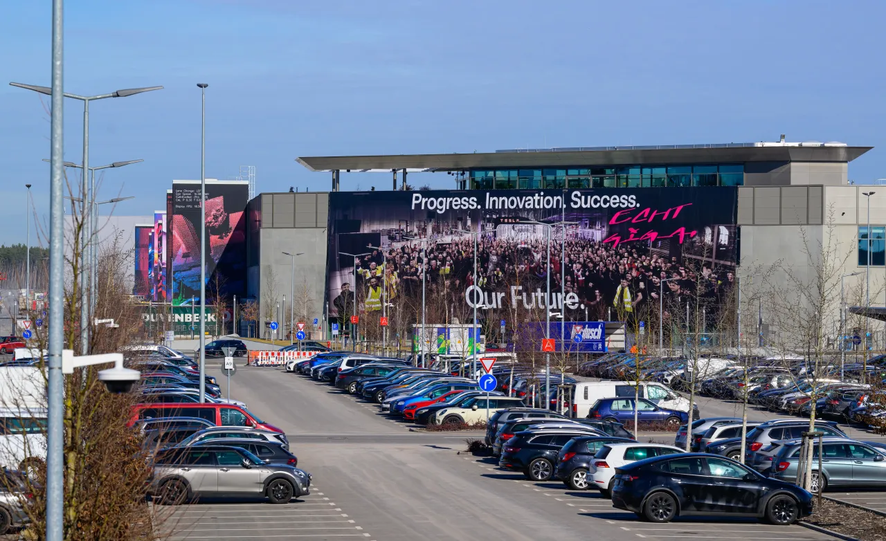 A huge banner (Progress. Innovation, Success. Our Future) hangs on the façade at the main entrance to the Tesla Gigafactory Berlin-Brandenburg. Photo: Patrick Pleul/dpa (Photo by Patrick Pleul/picture alliance via Getty Images)