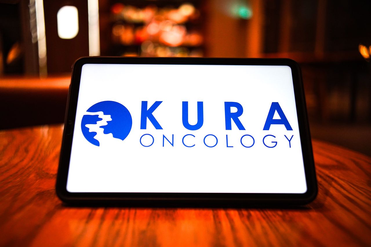 In this photo illustration, the logo of Kura Oncology is displayed on the screen of a smart tablet. (Photo Illustration by Sheldon Cooper/SOPA Images/LightRocket via Getty Images)