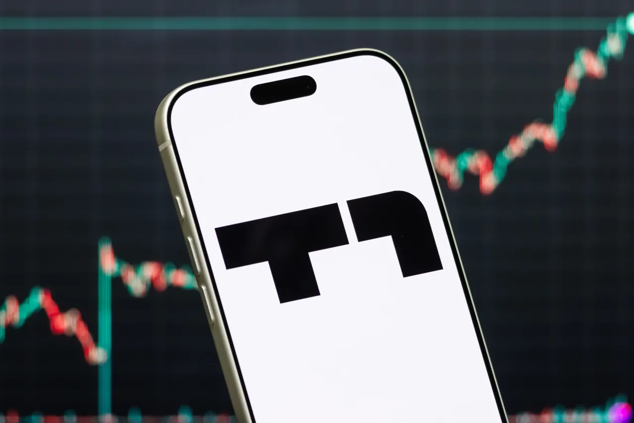 A smartphone displays the logo of T1 Energy Inc. (Photo illustration by Cheng Xin/Getty Images)