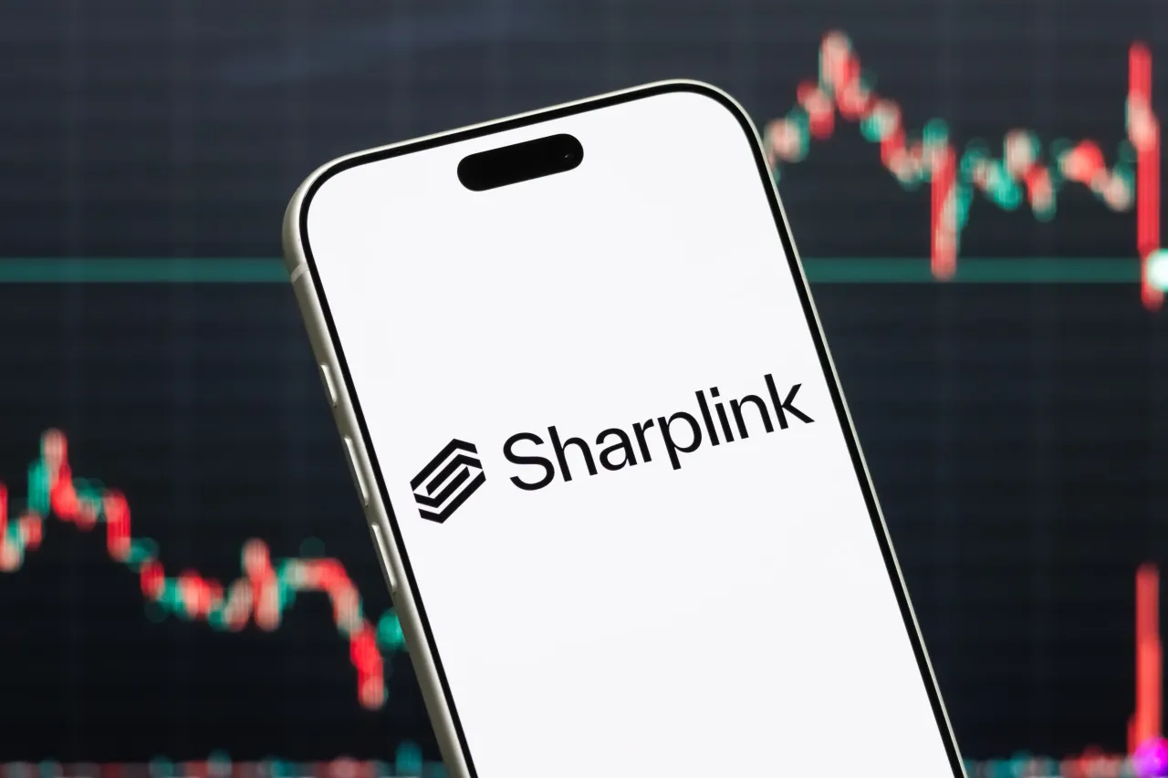 A smartphone displays the logo of SharpLink Gaming Ltd. (NASDAQ: SBET), a U.S.-based online marketing and technology company focused on sports betting and iGaming affiliate services. (Photo illustration by Cheng Xin/Getty Images)