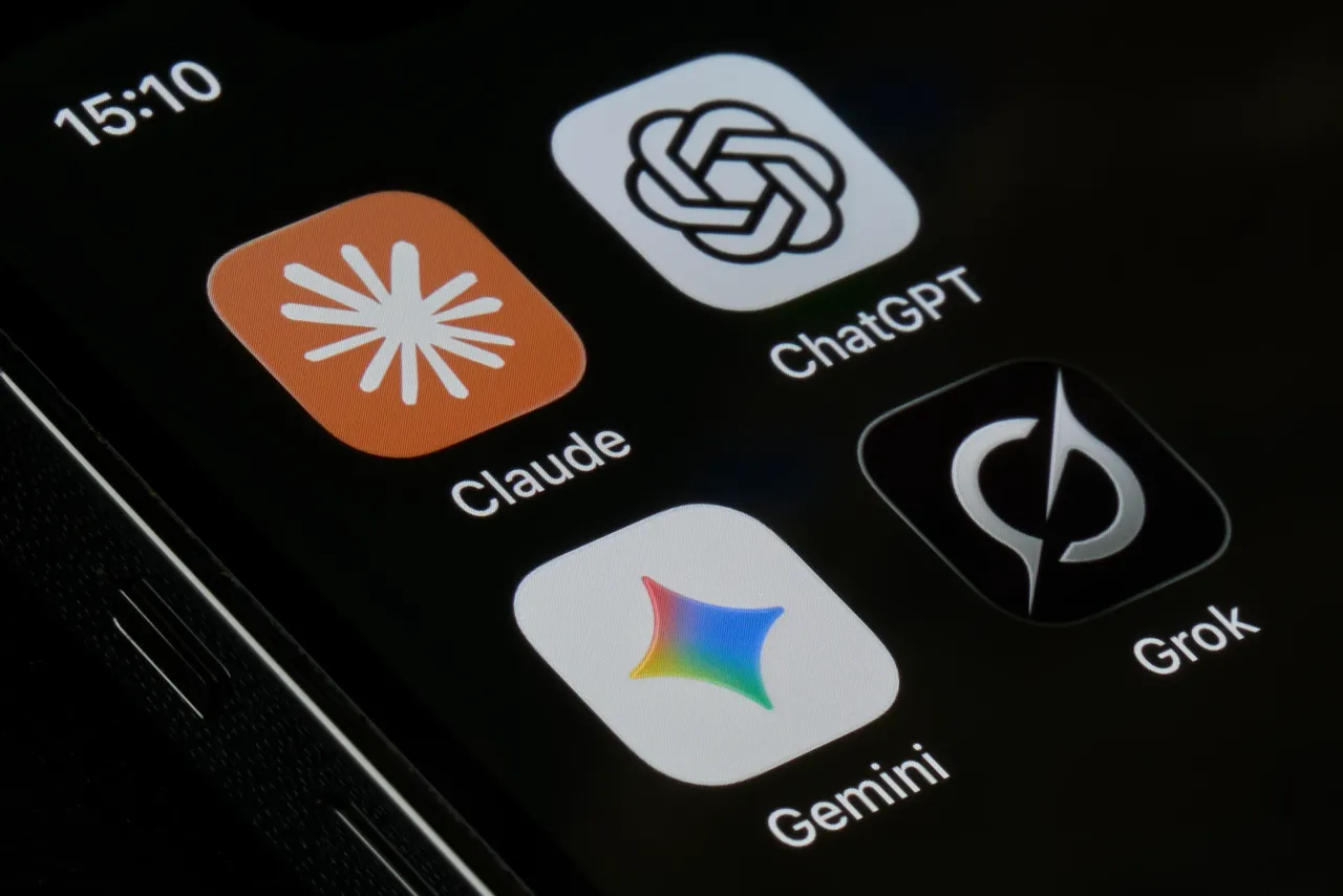 An iPhone screen photographed displays four AI assistant applications Claude by Anthropic, ChatGPT by OpenAI, Gemini by Google, and Grok by xAI. (Photo Illustration by Matteo Della Torre/NurPhoto via Getty Images)