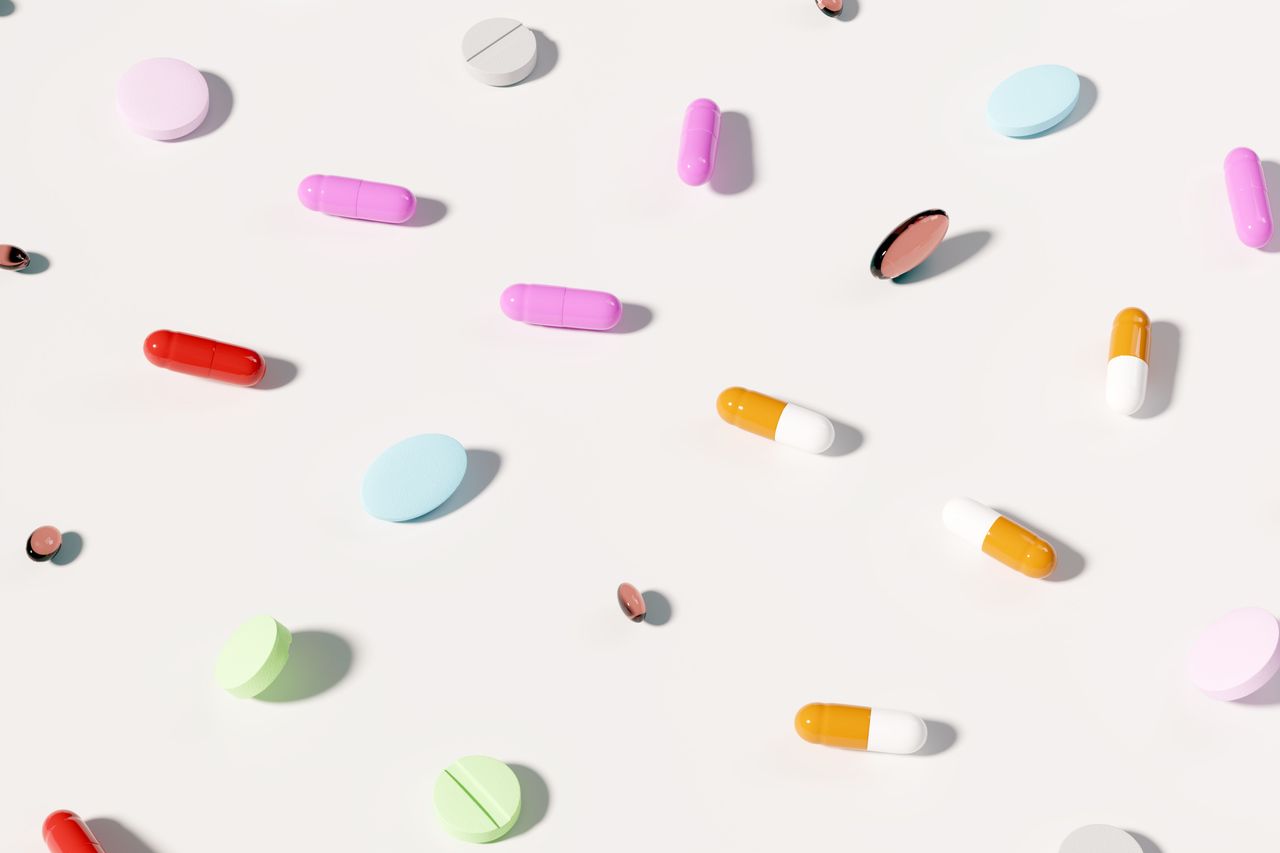 Assortment of colorful tablets, capsules, and softgel supplements arranged in a clean repeating pattern against a minimal background. Source: Getty Images