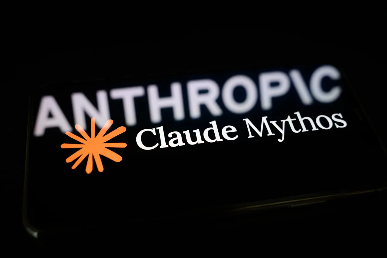The Claude Mythos logo is displayed on the screen of a smartphone placed on a reflective surface onto which the Anthropic logo. (Photo by Samuel Boivin/NurPhoto via Getty Images)