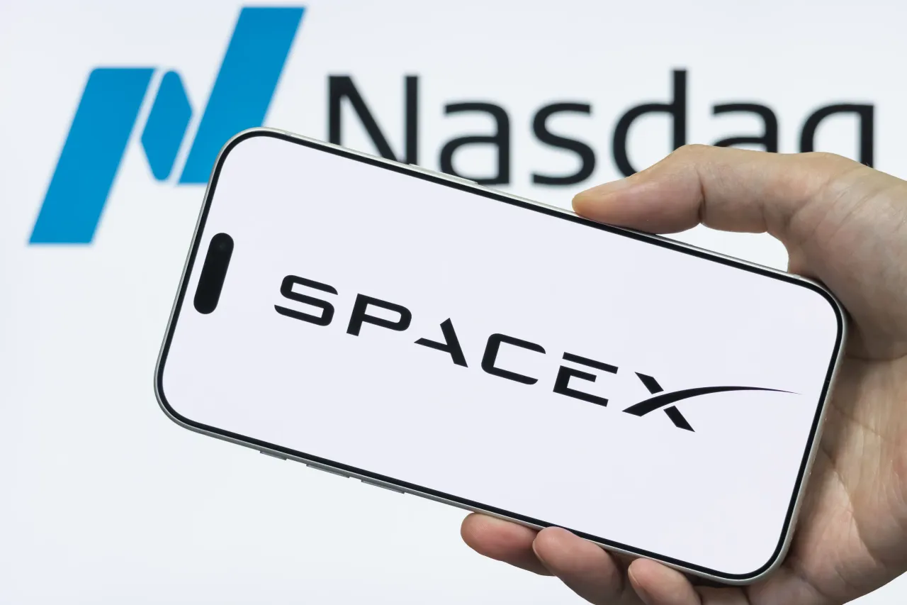 In this photo illustration, a smartphone displays the SpaceX logo in front of a Nasdaq logo on June 11, 2026, in Shenzhen, Guangdong Province, China. (Photo illustration by Cheng Xin/Getty Images)