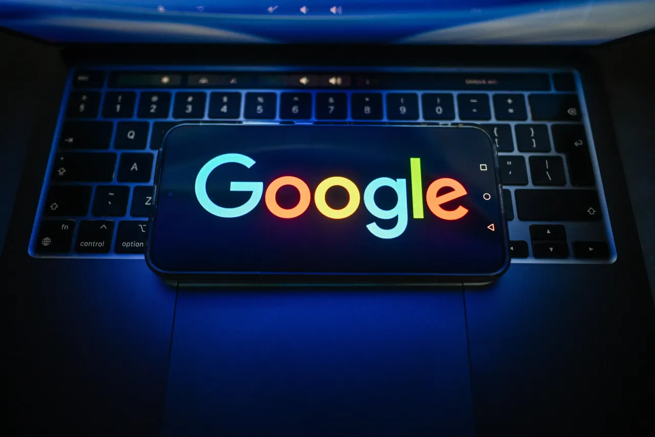 A Google logo is seen displayed on a smartphone on the top of a laptop. (Photo Illustration by Omar Marques/SOPA Images/LightRocket via Getty Images)