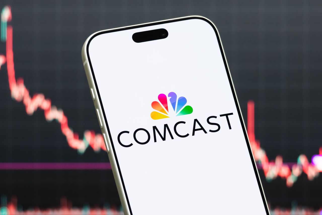In this photo illustration, a smartphone displays the logo of Comcast Corporation