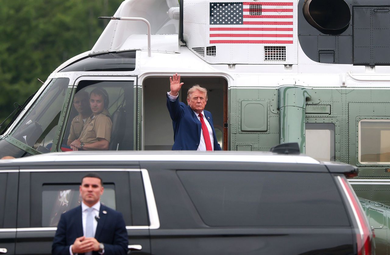 U.S. President Donald Trump waves while boarding Marine One.
