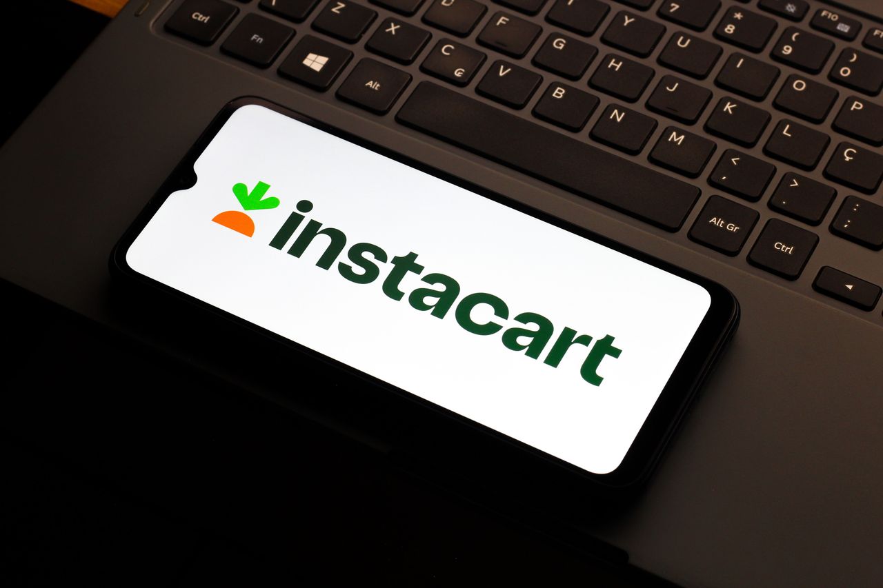 In this photo illustration, the Instacart logo is seen displayed on a smartphone screen.