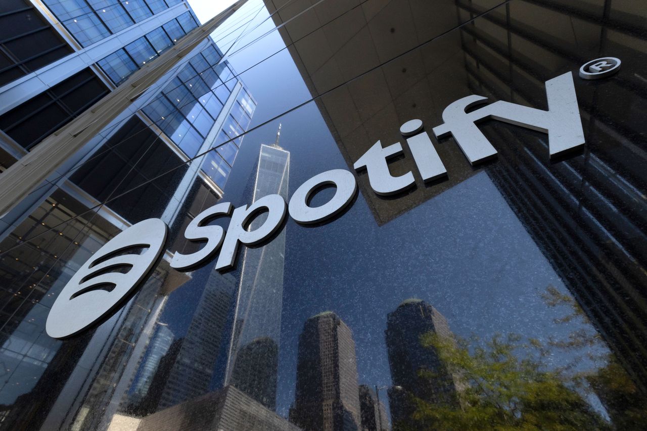 A Spotify corporate logo hangs on the front of its office at 4 World Trade Center as One World Trade Center is reflected in a window on September 7, 2026, in New York City. (Photo by Gary Hershorn/Getty Images)