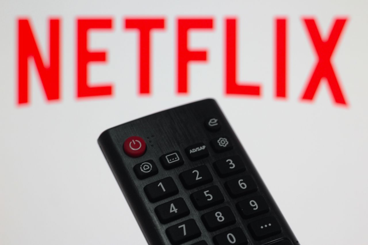 In this photo illustration, a close-up of the remote control and the Netflix logo on the TV screen.