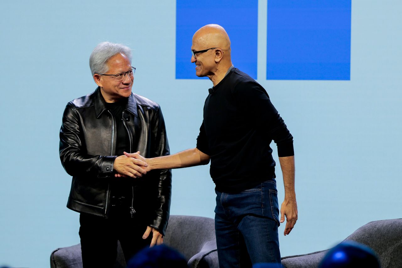 Nvidia CEO Jensen Huang (L) and Microsoft CEO Satya Nadella shake hands at a Windows event on October 07, 2026 in San Francisco, California. (Photo by Heather Diehl/Getty Images)