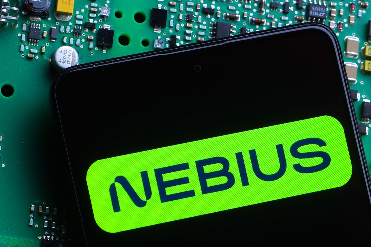 In this photo illustration, the Nebius Group logo is seen displayed on a smartphone screen with a green circuit board in the background. (Photo Illustration by Thomas Fuller/SOPA Images/LightRocket via Getty Images)