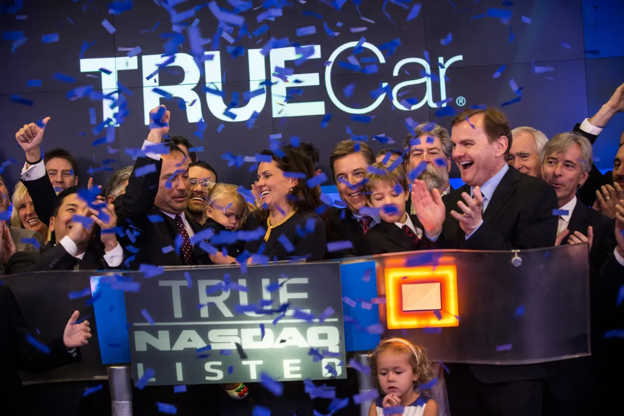 Employees of TrueCar celebrate while ringing the opening bell for the Nasdaq Exchange in Times Square on May 16, 2014 in New York City. TrueCar was having it's initial public offering (IPO) on the Nasdaq exchange. (Photo by Andrew Burton/Getty Images)