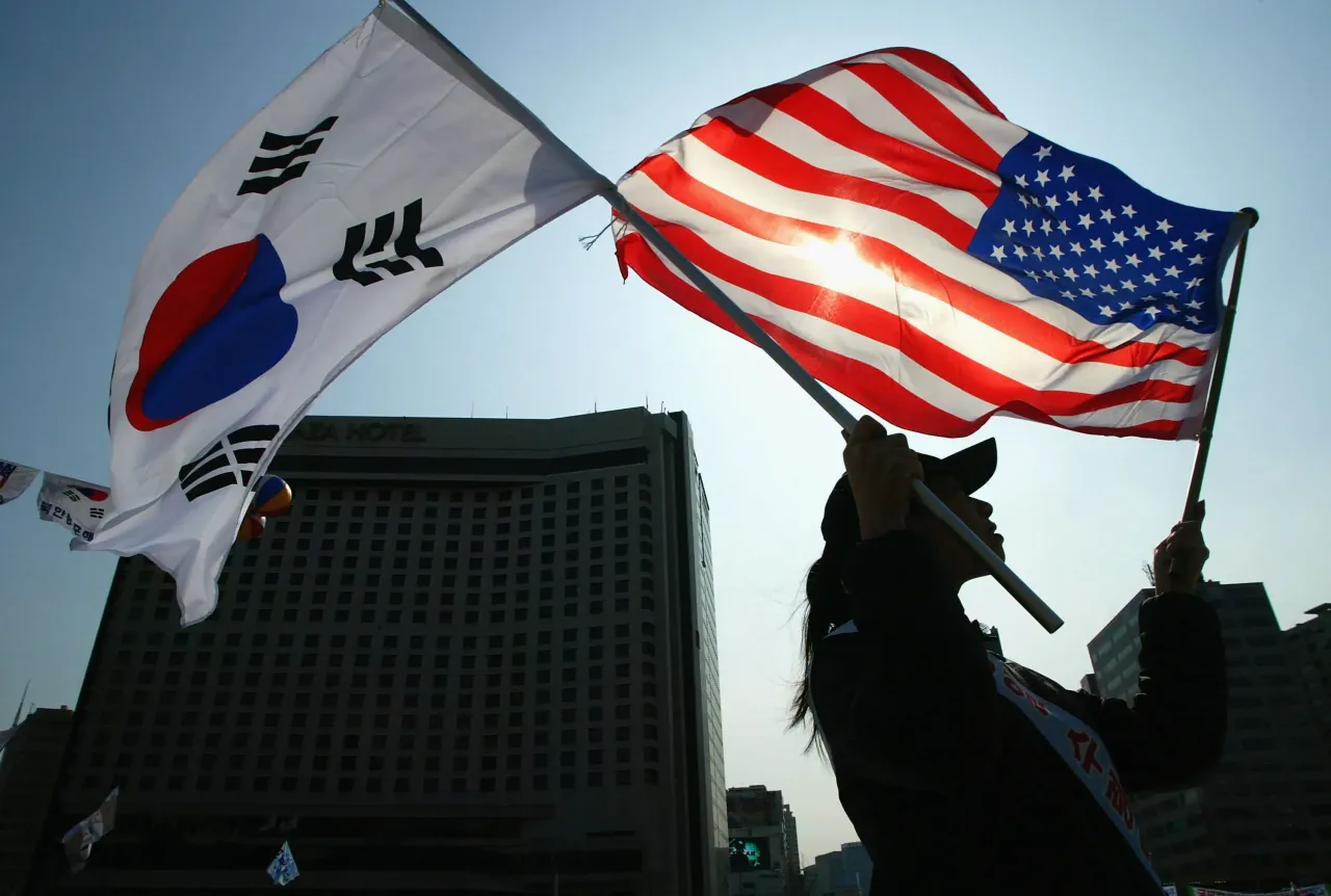 A South Korean women holds a South Korean and U.S. flag during the celebration of The March First Independence Movement Anniversary on March 1, 2005 in Seoul, South Korea. 