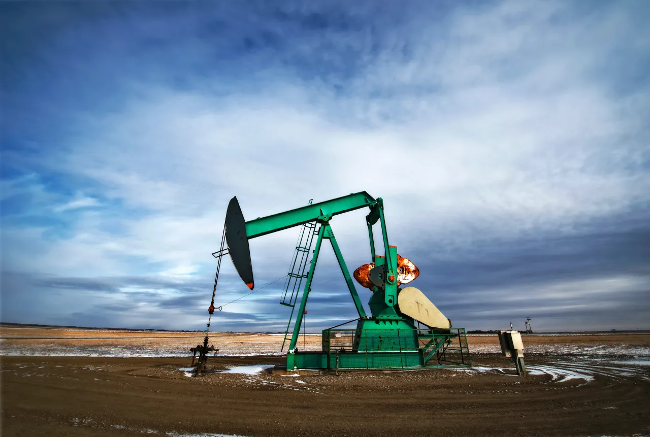 An oil pump jack at a drilling site for oil, an oil field in Saskatchewan. 