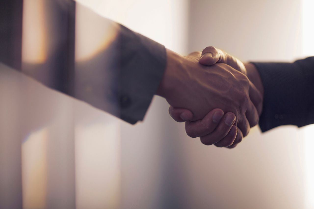 Handshake in contemporary office space