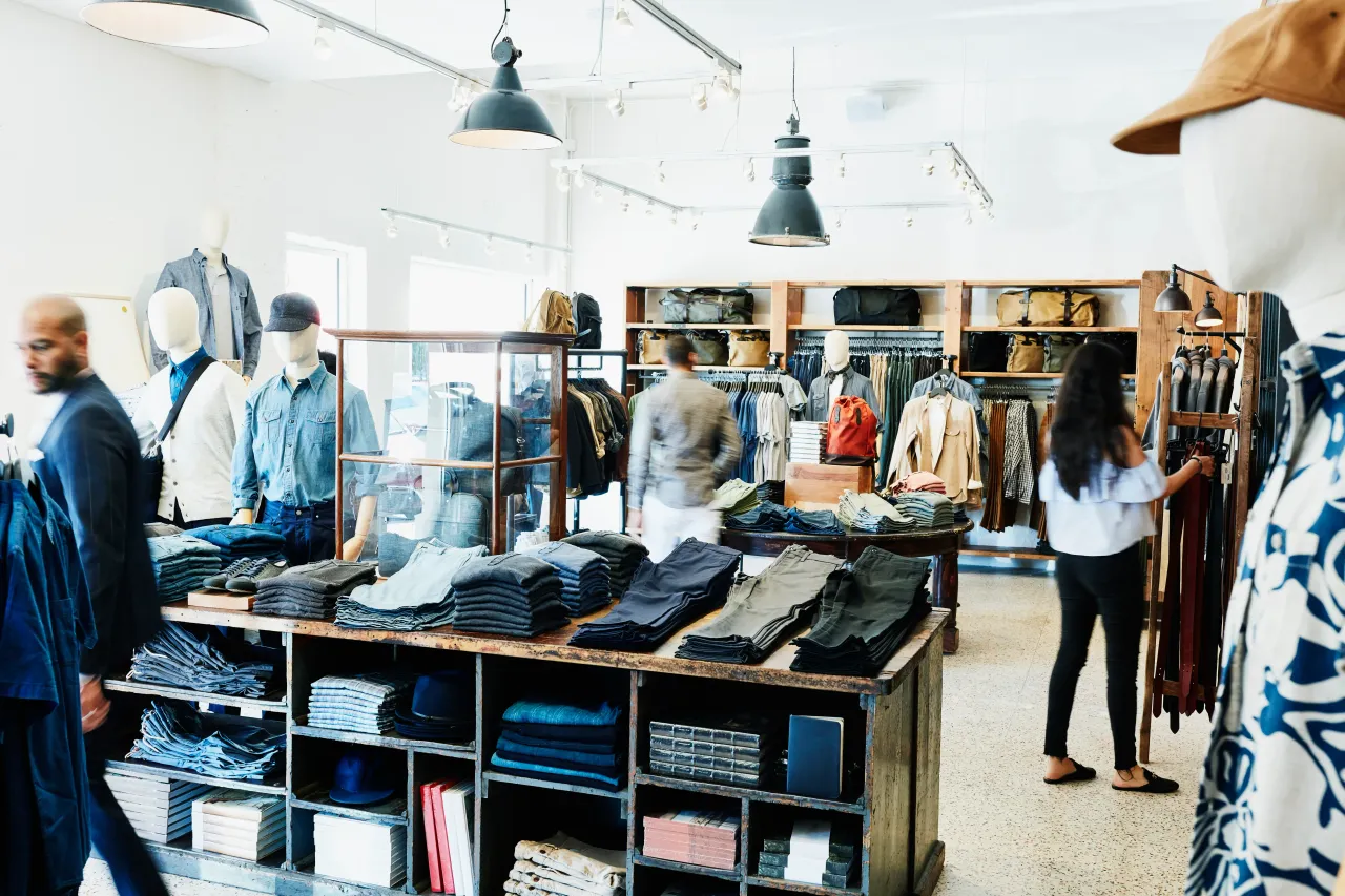 Shoppers looking at items in mens clothing boutique. (Stock photo/Getty Images)