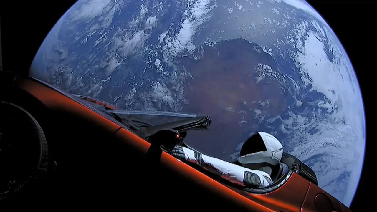  In this handout photo provided by SpaceX, a Tesla roadster launched from the Falcon Heavy rocket with a dummy driver named "Starman" heads towards Mars. (Photo by SpaceX via Getty Images)