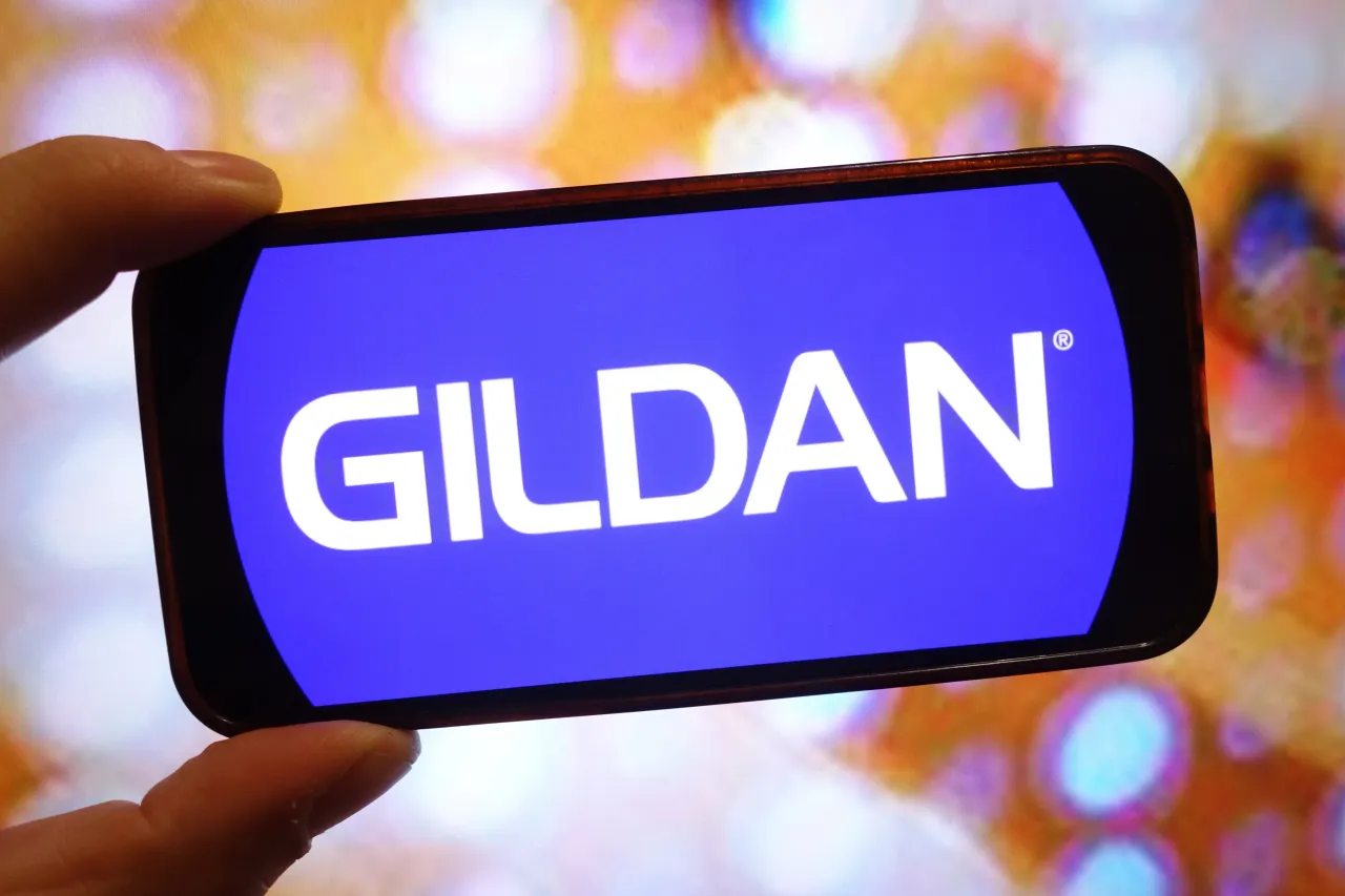 In this photo illustration, the Gildan company logo is seen displayed on a smartphone screen.