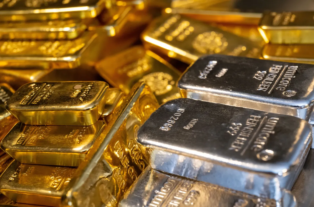 Bavaria, Munich: Gold and silver bars of various sizes lie in a safe on a table at the precious metals dealer Pro Aurum. 