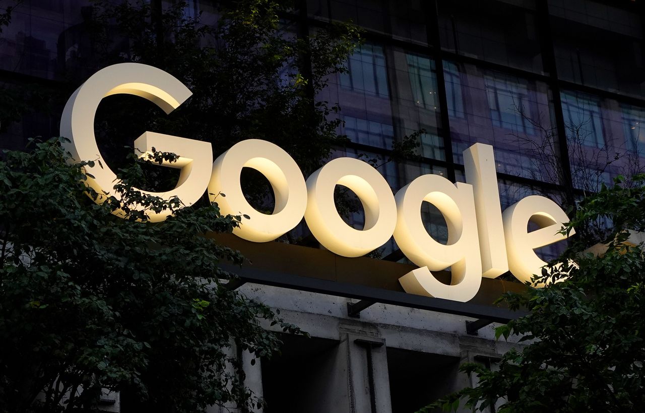 A Google corporate logo hangs above the entrance of their St. John's Terminal office building in New York City. (Photo by Gary Hershorn/Getty Images)