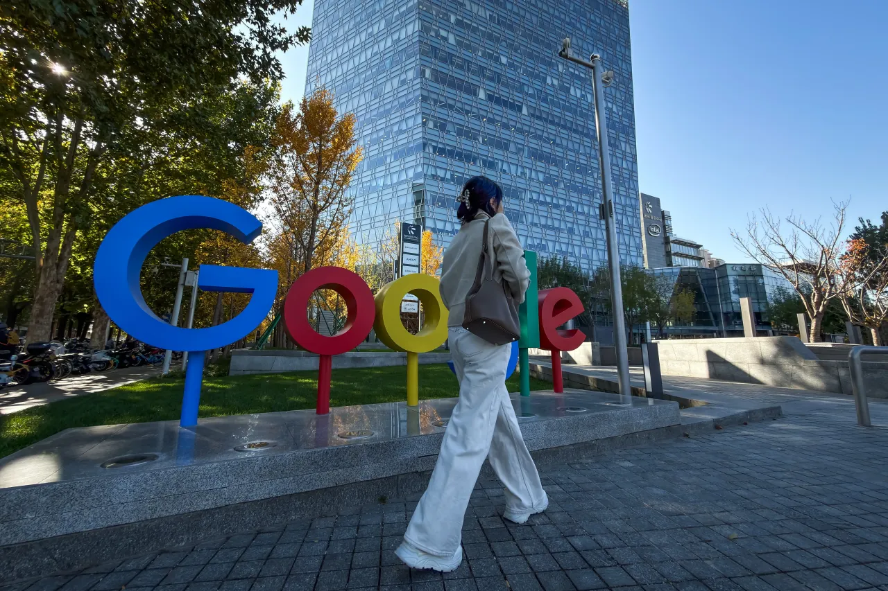 A pedestrian walks past the Google logo outside a commercial building that houses the company's Beijing office on November 11, 2025, in Beijing, China. 