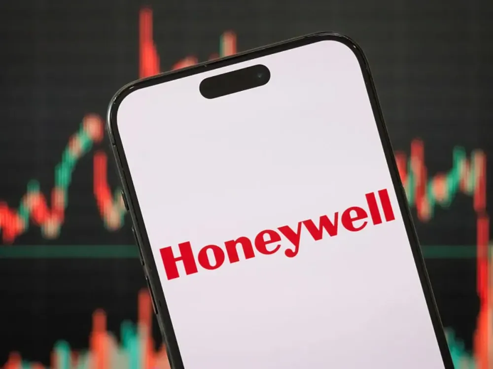  In this photo illustration, the logo of Honeywell International Inc. is displayed on a smartphone screen, with a stock market chart visible in the background.