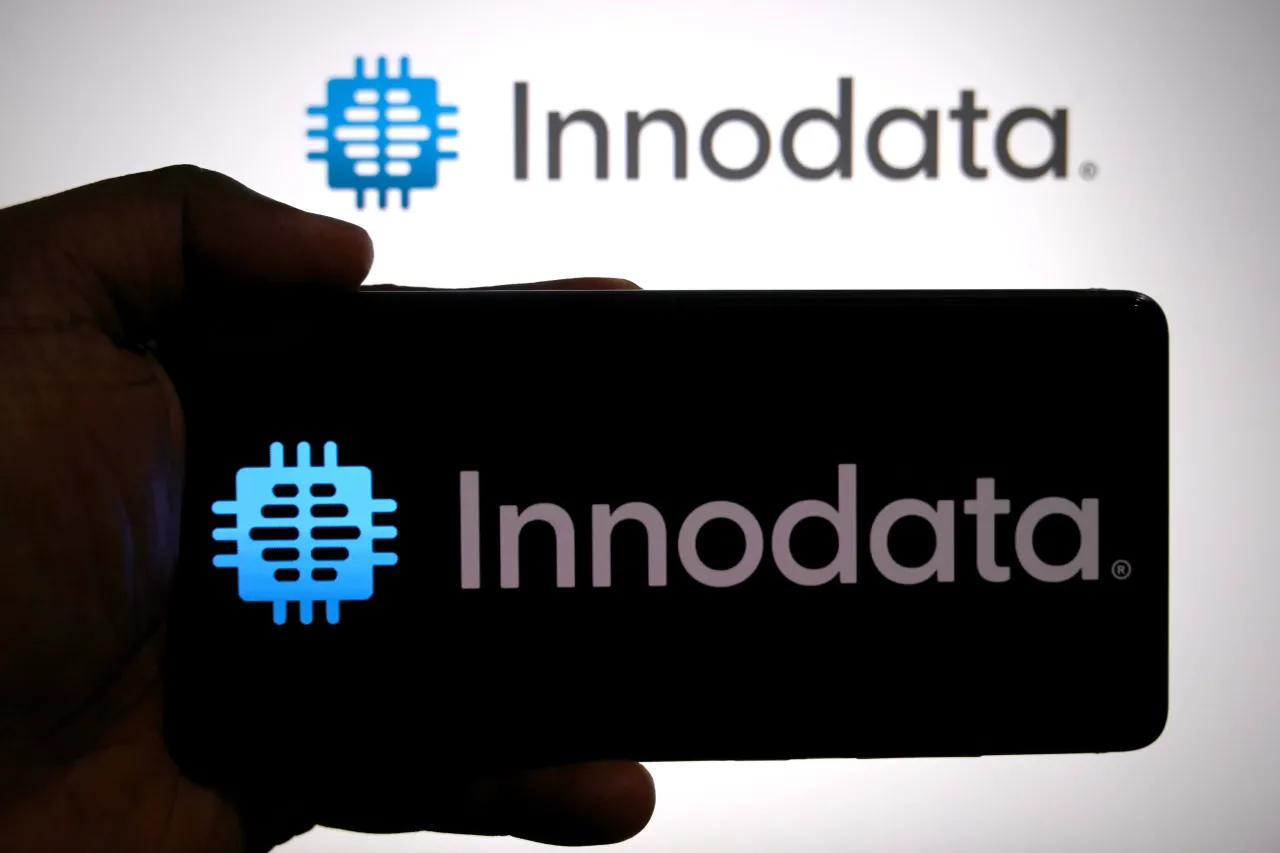 In this photo illustration, the Innodata logo is seen displayed on a smartphone and in the background.