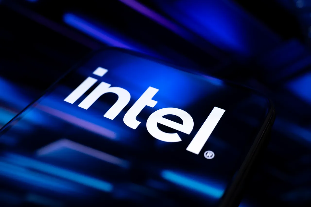  In this photographic illustration, the Intel logo appears on a smartphone reflecting an abstract illustration dominated by blue and black, on September 22, 2025. 