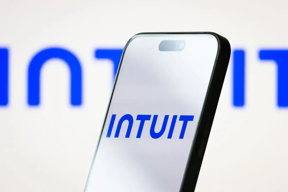 In this photo illustration, the logo of Intuit Inc. is displayed on a smartphone screen, with the company's blue branding in the background, on May 18, 2025, in Chongqing, China. 