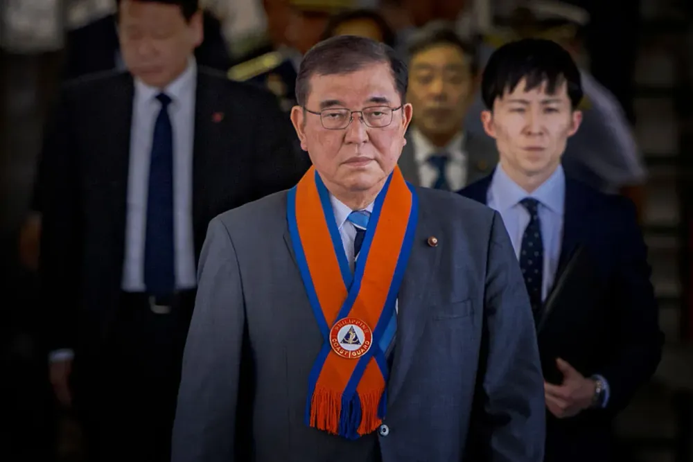 Japanese Prime Minister Shigeru Ishiba walks aboard the BRP Teresa Magbanua ship as he visits the Philippine Coast Guard headquarters on April 30, 2025 in Manila, Philippines. 
