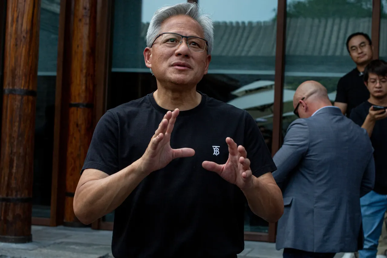 Nvidia founder and CEO Jensen Huang speaks to journalists as he arrives for a press conference at Mandarin Oriental Hotel on July 16, 2025 in Beijing, China. 