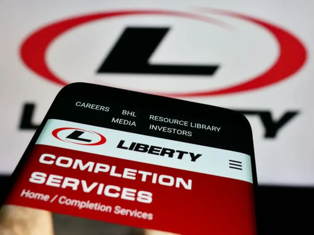 In this photo illustration, a smartphone with the website of US oilfield services company Liberty Energy Inc. is seen in front of business logo. (Photo Illustration by Timon Schneider/SOPA Images/LightRocket via Getty Images)