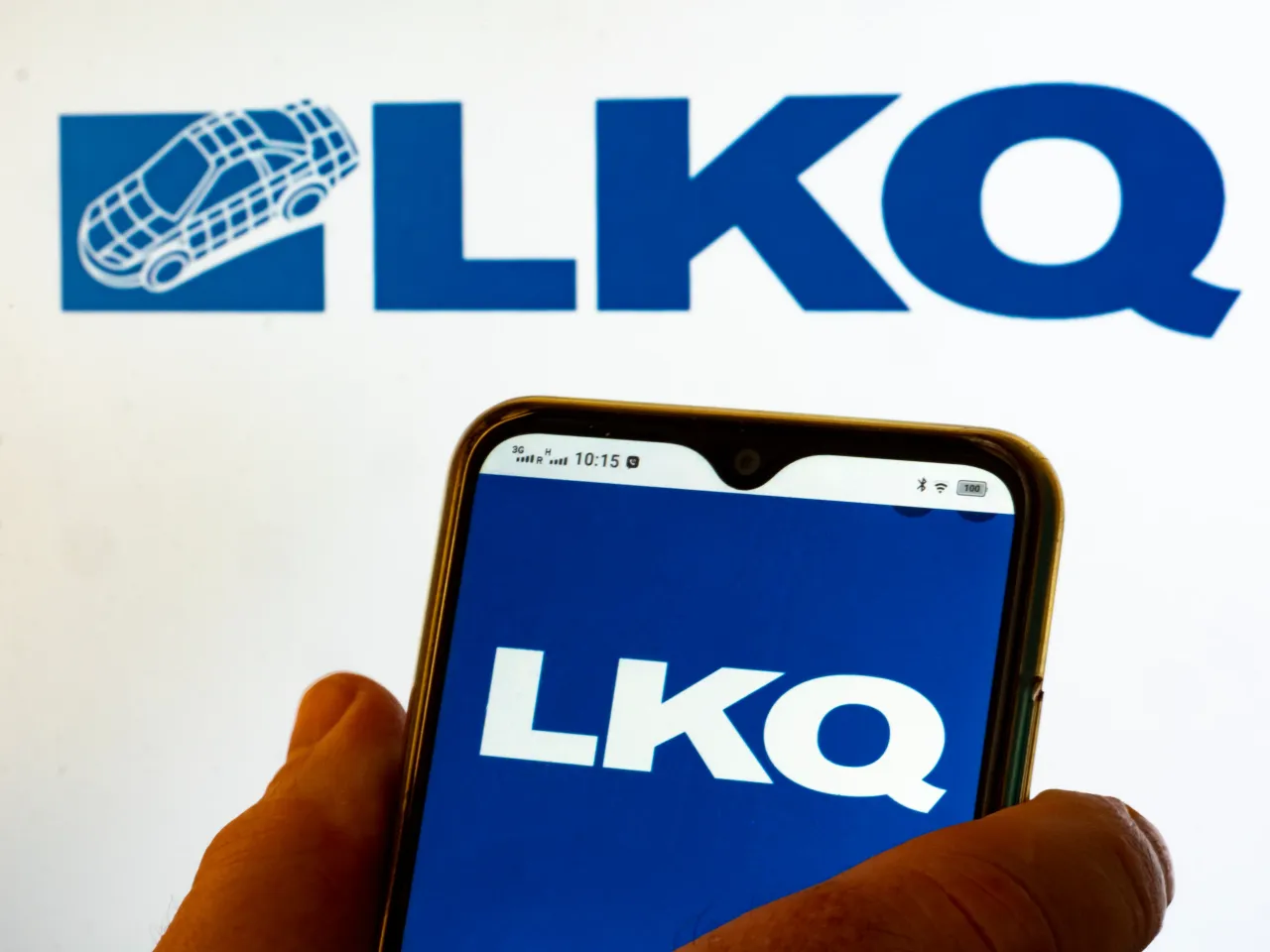 In this photo illustration LKQ Corporation logo seen displayed on a smartphone and on the background.
