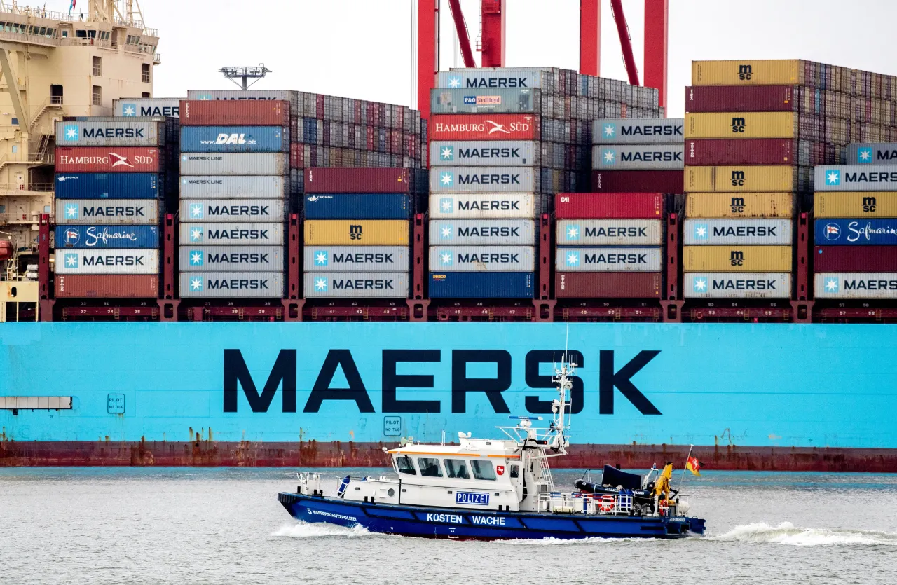: A boat of the Lower Saxony water police sails along in front of the container ship "Morten Maersk" of the Danish shipping company Maersk Line on March 20, 2023.