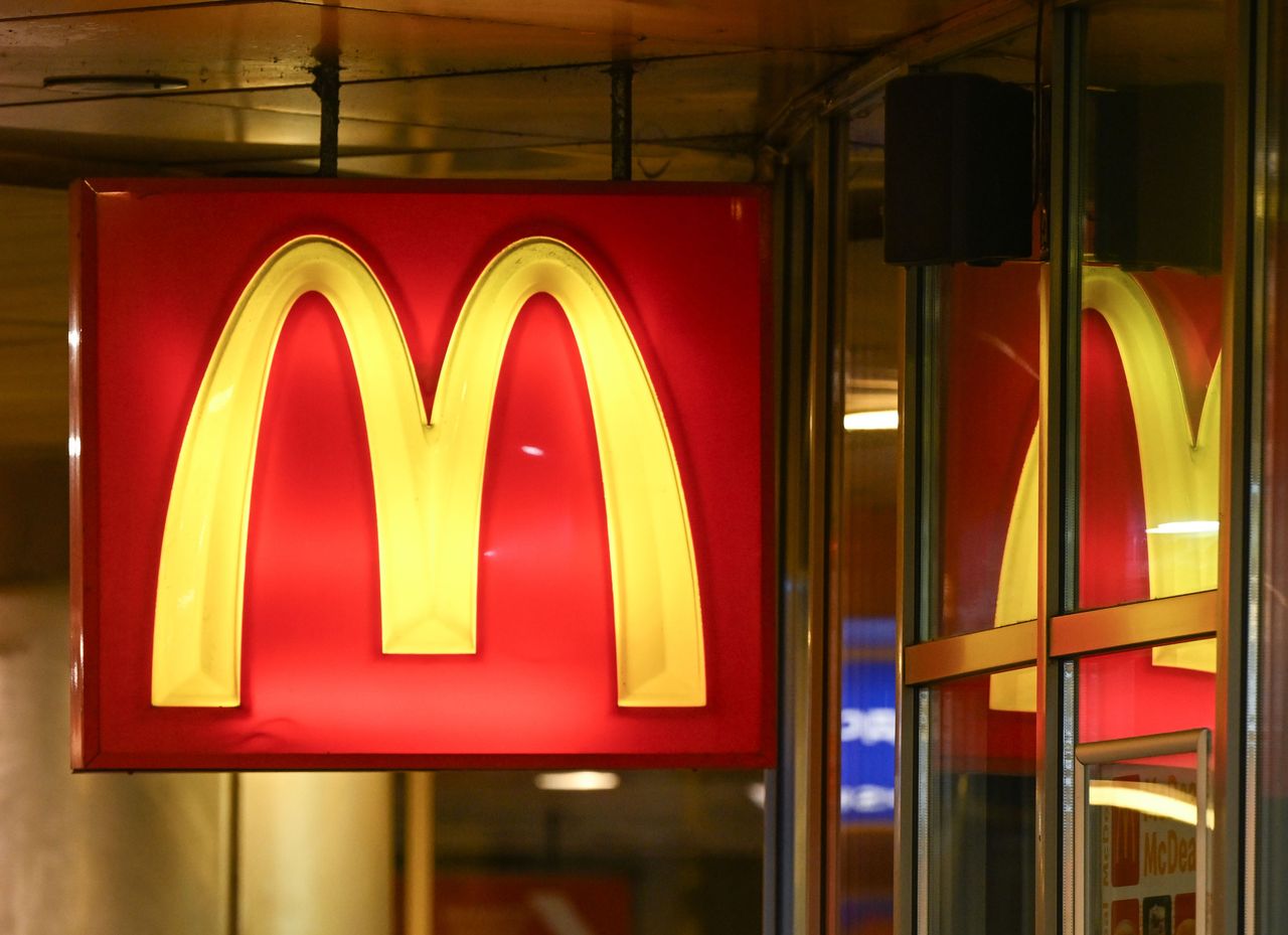 An illuminated square red sign featuring the golden arches logo of McDonald's reflects off glass windows at a restaurant in Sofia, Bulgaria. (Photo by Artur Widak/NurPhoto via Getty Images)