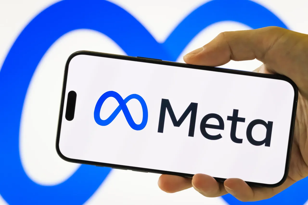 In this photo illustration, a person holds a smartphone displaying the logo of Meta Platforms Inc. (NASDAQ: META)von July 28, 2025 in Chongqing, China. 