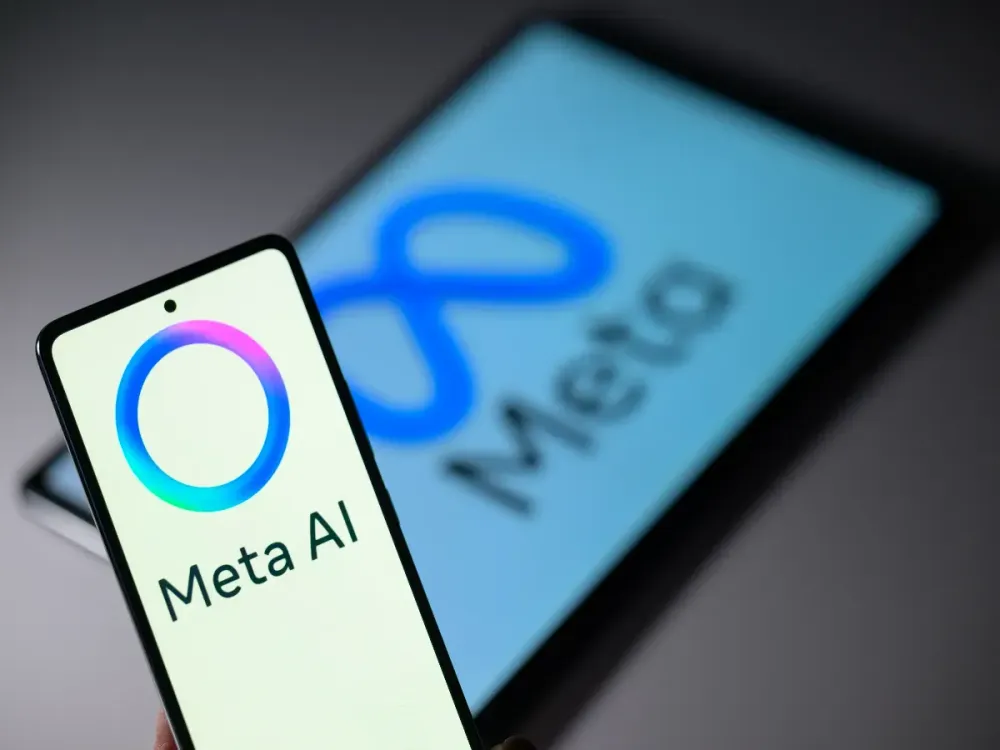 Meta AI is displayed on a mobile phone with the Meta logo visible on a tablet screen in this photo illustration in Brussels, Belgium, on January 7, 2025. (Photo by Jonathan Raa/NurPhoto via Getty Images)