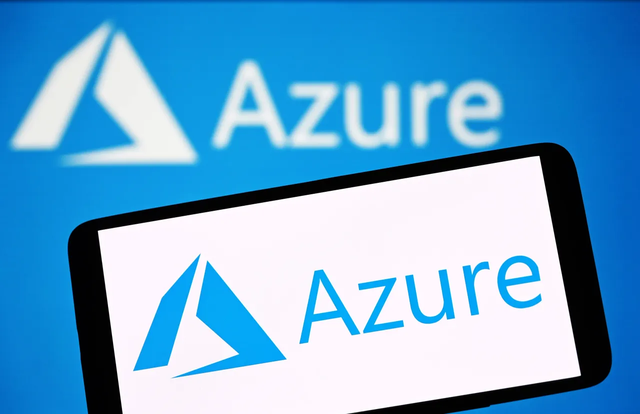 In this photo illustration, a Microsoft Azure logo is seen on a smartphone and in the background. 