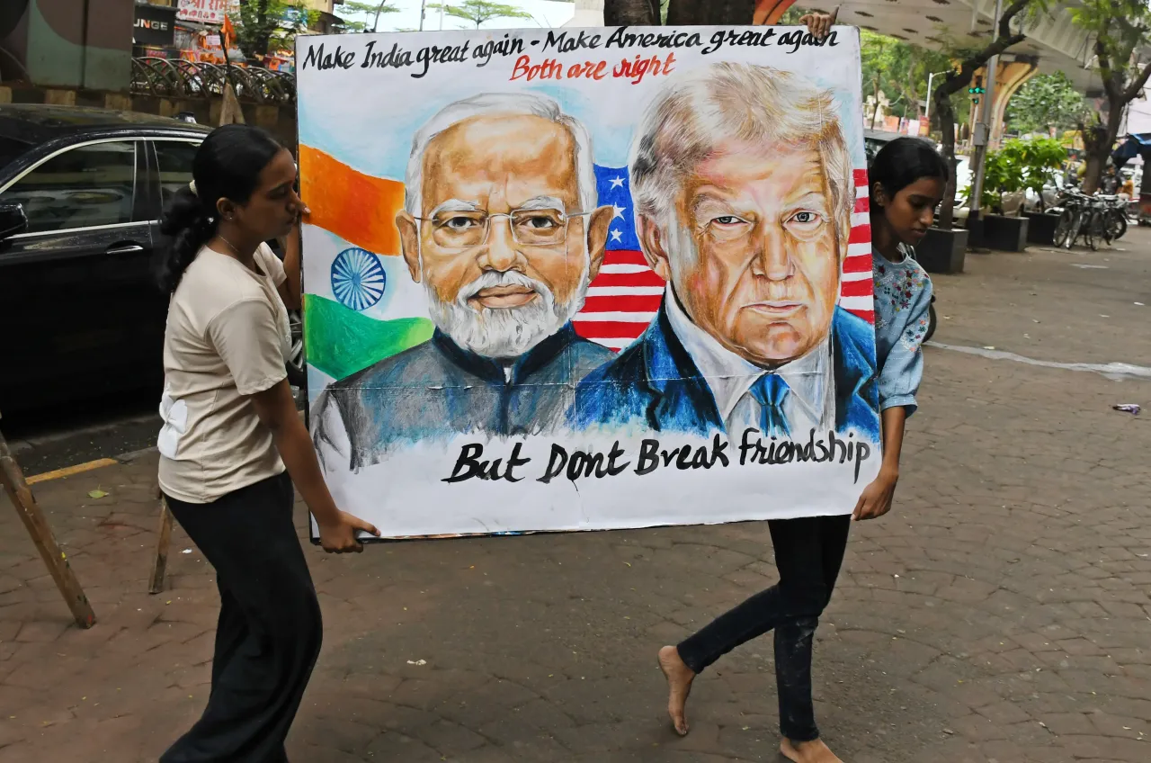 Students from Gurukul School of Art carry a poster of Prime Minister of India Narendra Modi and U.S. President Donald Trump outside their school. 