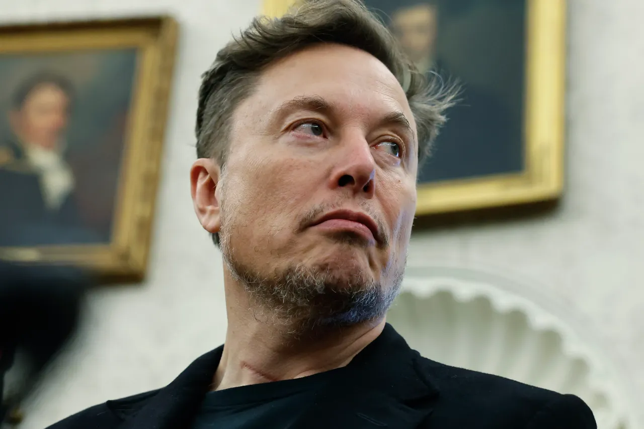 Elon Musk listens as reporters ask U.S. President Donald Trump and South Africa President Cyril Ramaphosa questions during a press availability in the Oval Office at the White House on May 21, 2025.