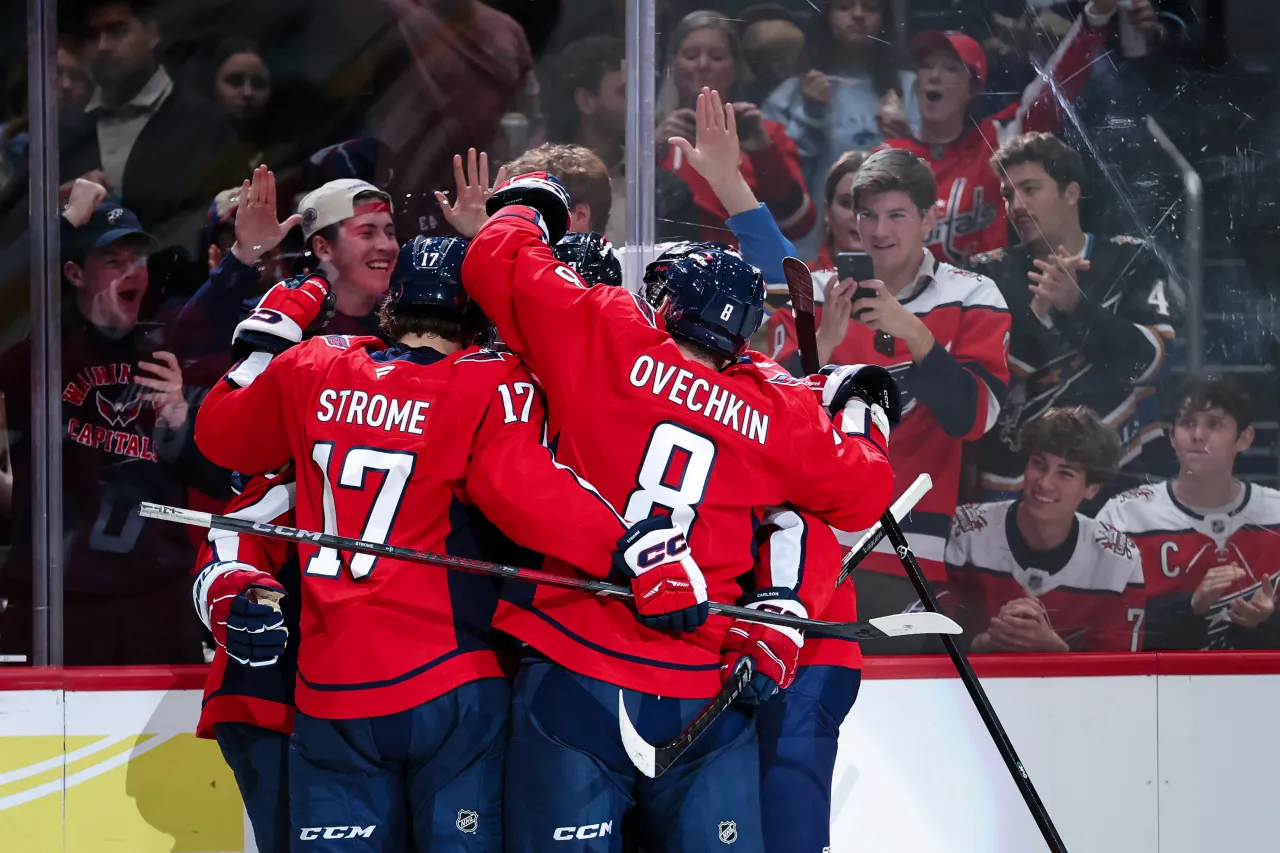 Jakob Chychrun #6 of the Washington Capitals celebrates with Alex Ovechkin #8, Dylan Strome #17 and teammates.