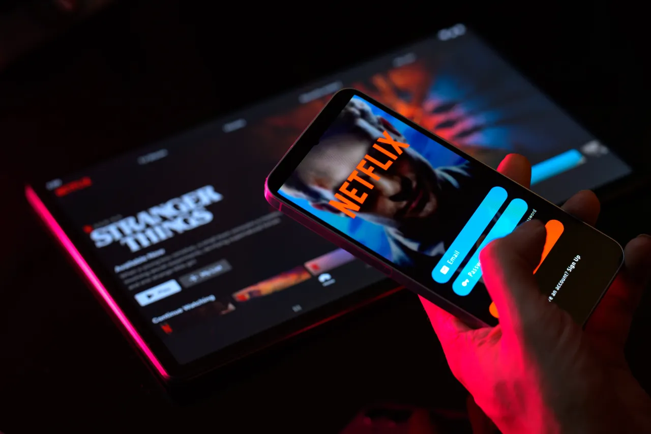 The Netflix login screen is displayed on a phone screen with Netflix visible in the background in this photo illustration in Brussels, Belgium, on January 5, 2025. 