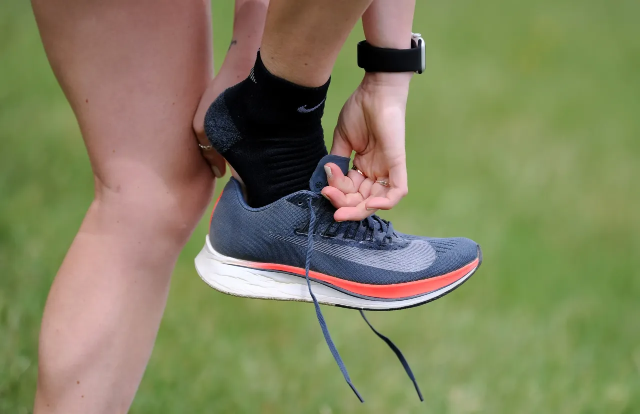 A detailed view as British marathon runner Charlotte Purdue changes her Nike trainers during a training session on June 29, 2020 in East Molesey, England.